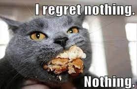 A meme of a cat with a mouthful of cake.